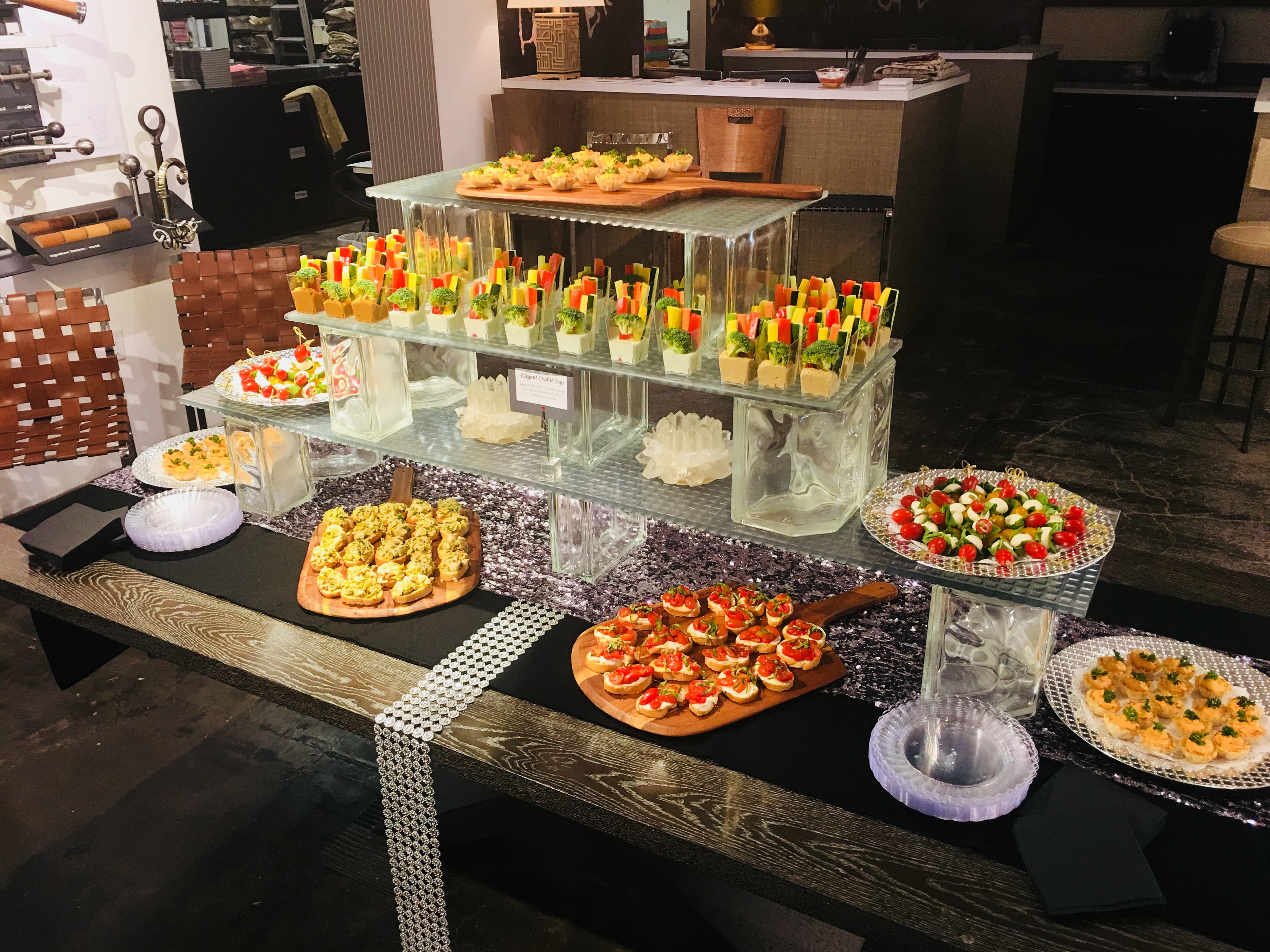 Tiered grazing display with crudités, bruschetta, and skewers