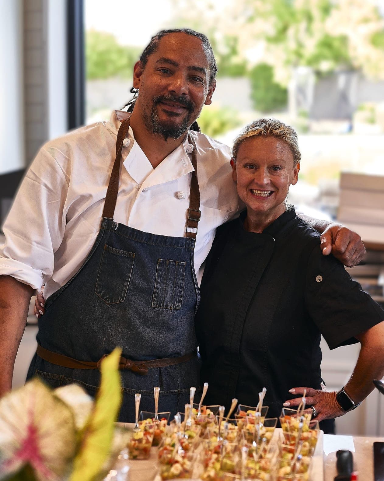 Two Emily's Events staff members plating passed appetizers at an event